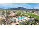 Aerial view highlighting a golf course with water features, complemented by stunning mountain views at 6648 S Lyon Dr, Gilbert, AZ 85298