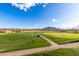 Scenic golf course view with lush green fairways and distant mountains, providing a picturesque backdrop for golfers at 6648 S Lyon Dr, Gilbert, AZ 85298
