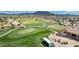 An aerial view of the lush green golf course, with sand traps and a small building nearby at 6648 S Lyon Dr, Gilbert, AZ 85298