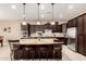 Modern kitchen with granite countertops, stainless steel appliances, and dark wood cabinetry at 6648 S Lyon Dr, Gilbert, AZ 85298