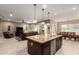 Open-concept kitchen with granite island flows into living and dining areas, perfect for entertaining at 6648 S Lyon Dr, Gilbert, AZ 85298