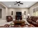 Spacious living room featuring comfortable leather seating, an entertainment center, and a neutral color scheme for a relaxing ambiance at 6648 S Lyon Dr, Gilbert, AZ 85298
