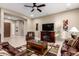Cozy living room with leather seating, tiled floors, entertainment center, and recessed lighting for a warm and inviting atmosphere at 6648 S Lyon Dr, Gilbert, AZ 85298