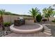 Outdoor kitchen featuring a BBQ grill, prep area, and a stone-accented base on a paved patio at 6648 S Lyon Dr, Gilbert, AZ 85298