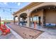 Covered outdoor patio with string lights, seating, and a bocce ball court, perfect for entertaining and enjoying the outdoors at 6648 S Lyon Dr, Gilbert, AZ 85298