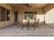 The covered patio is perfect for outside dining, overlooking the lush backyard. It has brick flooring and neutral walls at 6648 S Lyon Dr, Gilbert, AZ 85298