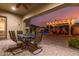 Relaxing covered patio area with an outdoor dining table and a view of pool at 6648 S Lyon Dr, Gilbert, AZ 85298