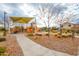 Neighborhood playground featuring slides, climbing structures, and shaded seating for caregivers at 6648 S Lyon Dr, Gilbert, AZ 85298