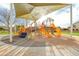 Covered playground featuring slides, climbing structures, and cushioned flooring for added safety at 6648 S Lyon Dr, Gilbert, AZ 85298