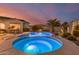 Relaxing inground spa with colorful lights in a beautiful backyard with pool and seating at 6648 S Lyon Dr, Gilbert, AZ 85298