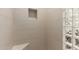 Modern walk-in shower with tile surround, niche, bench, and stylish glass block window at 6648 S Lyon Dr, Gilbert, AZ 85298