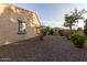 Low-maintenance side yard with desert landscaping and gravel, creating a clean and functional outdoor space at 6648 S Lyon Dr, Gilbert, AZ 85298