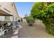 Low-maintenance side yard with gravel, stepping stones, and mature trees, enhancing the property's outdoor appeal at 6648 S Lyon Dr, Gilbert, AZ 85298