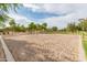 Outdoor sand volleyball court with net, poles and yellow boundary lines within a well-maintained community at 6648 S Lyon Dr, Gilbert, AZ 85298