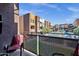 Balcony view showcasing complex, pool, and surrounding multi-story buildings on a sunny day at 6745 N 93Rd Ave # 1158, Glendale, AZ 85305