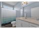 Well-lit bathroom with a vanity, neutral tones, and a shower featuring a stylish shower curtain at 6745 N 93Rd Ave # 1158, Glendale, AZ 85305
