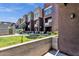 Exterior view of modern townhomes featuring manicured landscaping and private patios at 6745 N 93Rd Ave # 1158, Glendale, AZ 85305
