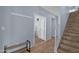 Inviting hallway with tiled floor, wood staircase, and access to other rooms at 6745 N 93Rd Ave # 1158, Glendale, AZ 85305