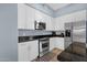 Well-equipped kitchen with white cabinets, stainless steel appliances, and granite countertops at 6745 N 93Rd Ave # 1158, Glendale, AZ 85305