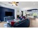 Open-concept living room with a fireplace, modern furniture, and seamless flow to the kitchen and dining area at 6745 N 93Rd Ave # 1158, Glendale, AZ 85305