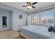 Spacious main bedroom featuring large windows, a ceiling fan, and a comfortable bed with stylish decor at 6745 N 93Rd Ave # 1158, Glendale, AZ 85305