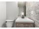 Modern bathroom features a light wood vanity, a square sink, a wall mirror, and a white elongated toilet at 725 S Power Rd # 101, Mesa, AZ 85206