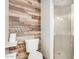 Modern bathroom featuring stylish wood-look accent wall and walk-in shower at 725 S Power Rd # 101, Mesa, AZ 85206