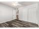 Bedroom featuring wood-look flooring, neutral walls, a ceiling fan, and a closet with sliding doors at 725 S Power Rd # 101, Mesa, AZ 85206