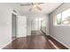 A bedroom with new floors, a ceiling fan, and a mirrored closet at 725 S Power Rd # 101, Mesa, AZ 85206