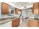 Functional kitchen with modern appliances and oak cabinets open to the living area at 725 S Power Rd # 101, Mesa, AZ 85206