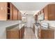 Well-lit kitchen featuring wood cabinetry and plenty of countertop space at 725 S Power Rd # 101, Mesa, AZ 85206
