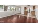 Open-concept living area with wood-look floors flowing into a tiled kitchen at 725 S Power Rd # 101, Mesa, AZ 85206