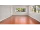Bright living room with wood floors and large windows showcasing the outdoor scenery at 725 S Power Rd # 101, Mesa, AZ 85206