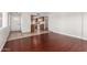 Bright living space featuring dark wood floors and access to the kitchen at 725 S Power Rd # 101, Mesa, AZ 85206