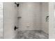 Contemporary shower featuring gray tile, a black shower head, a built-in soap dish, and a tile accent niche at 725 S Power Rd # 101, Mesa, AZ 85206