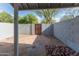 Enclosed back patio with stone pavers, block fencing, and a convenient access gate at 860 N Mcqueen Rd # 1151, Chandler, AZ 85225