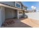 Private back patio with stone pavers, gray fencing, and convenient access gate at 860 N Mcqueen Rd # 1151, Chandler, AZ 85225