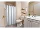 Cozy bathroom featuring a shower with white curtain, modern vanity, and neutral wall shelves at 860 N Mcqueen Rd # 1151, Chandler, AZ 85225