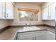 Bright kitchen featuring white cabinetry, natural light, and modern faucet at 860 N Mcqueen Rd # 1151, Chandler, AZ 85225