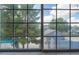 A picturesque view of a sparkling pool and lush landscaping through a large window at 860 N Mcqueen Rd # 1151, Chandler, AZ 85225