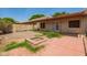 Fire pit and brick patio combined with desert landscape, ideal for relaxing outdoors at 9106 N 68Th Ln, Peoria, AZ 85345