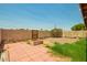 Well-defined backyard featuring a mix of greenery, a brick patio, and a fire pit at 9106 N 68Th Ln, Peoria, AZ 85345