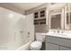 Cozy bathroom with gray accents, featuring combined tub and shower and storage cabinets at 9106 N 68Th Ln, Peoria, AZ 85345