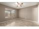 This bedroom has natural light, a ceiling fan, and wood-look tile flooring at 9106 N 68Th Ln, Peoria, AZ 85345