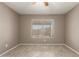 Bright bedroom with wood-look tile flooring and a large window for natural light at 9106 N 68Th Ln, Peoria, AZ 85345
