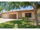 Charming single-story home featuring an open carport and well-maintained front yard landscaping at 9106 N 68Th Ln, Peoria, AZ 85345
