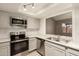 The kitchen features stainless steel appliances, subway tile, and quartz countertops at 9106 N 68Th Ln, Peoria, AZ 85345