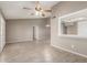 Bright living room featuring tile floors, a ceiling fan, and an open view to the kitchen at 9106 N 68Th Ln, Peoria, AZ 85345