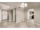 Open-concept living room boasts tile floors, neutral tones, and a view to the kitchen at 9106 N 68Th Ln, Peoria, AZ 85345