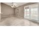 Bright room boasts tile floors, natural light from a sliding glass door, and a ceiling fan at 9106 N 68Th Ln, Peoria, AZ 85345